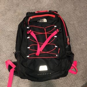 Charcoal grey and neon pink north face backpack